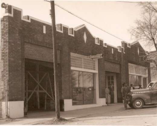 Old Ford Motor Co. JV Bostic standing in the doorway. Ollie Brown leaning on the car. (Shared by Carolyn Mohr)