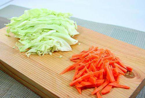 Cut your cabbage up into very thin strips. Your carrots also need to be cut into thin long strips. Make sure your strips for both are long and narrow.