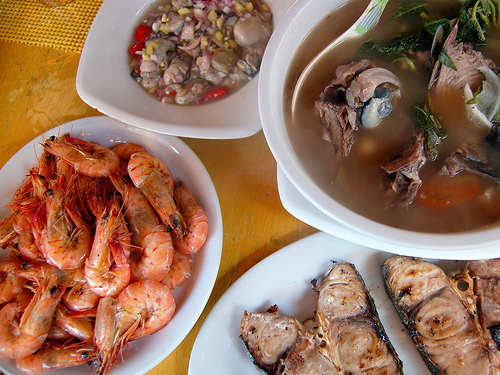 Seafood Lunch in Boracay, Philippines - Stir-Fried Shrimps, Grilled Blue Marlin, Tuna Head in Sour Broth, and Raw Oyster Meat in Spicy Vinegar (Photo courtesy by ~MVI~ from Flickr.com)