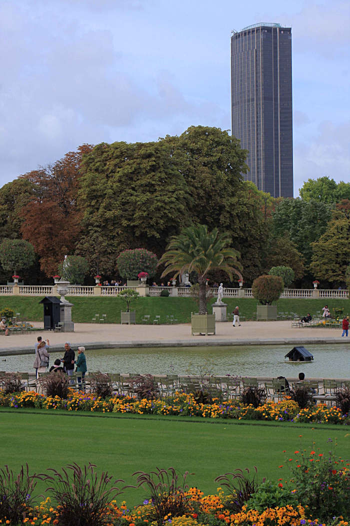 The Montparnasse Tower as seen from the Jardin du Luxembourg. The outdoor viewing platform is shielded with glass (or clear plastic?), but with ample wide gaps to allow for clear viewing and photography
