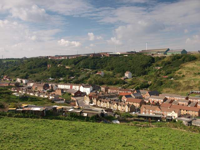Skinningrove village seen from the old jetty trackbed, with the much rationalised, almost phased out steel works on the plateau behind