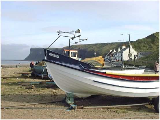 Inshore fishing vessels on Saltburn seafront looking towards Huntcliffe past Old Saltburn (the Ship Inn is the nearesr building with the white end wall