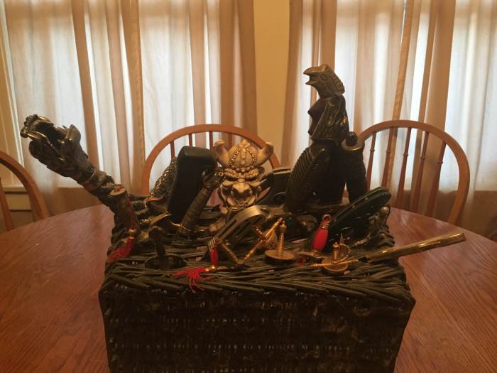Displaying knives can be the hardest thing to do. In this case I stuck the blade of each knife into a basket so that just the hilt is exposed.