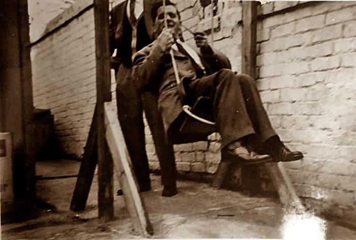 Grandad fooling around on my brother's old swing in the garden of grandma's B&B. He always had a great sense of fun. That's my brother in the background, pushing him!