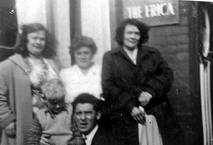 Grandad kneeling at the front with my brother Eric, grandma in the centre and guests at the bed & breakfast grandma ran, which was called The Erica