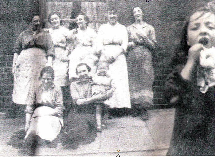 Grandad's mum Annie (standing in the centre) and her sister Mary (standing on the right) with their neighbours in Hunslet Carr around the time of World War One.