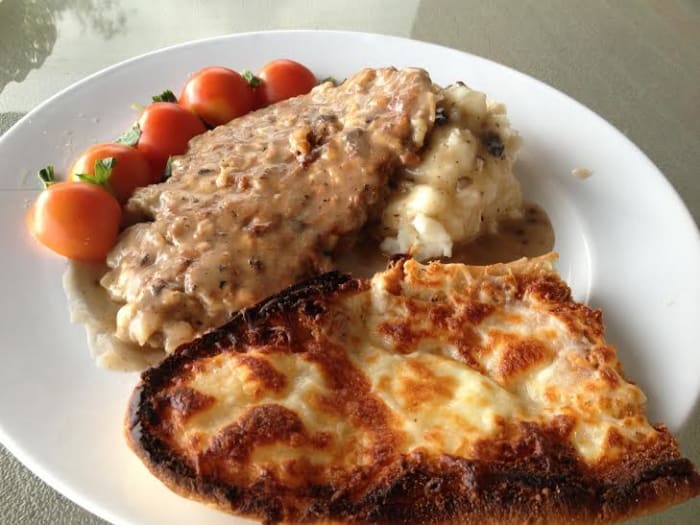 The finished dinner. Cube Steak with mushroom gravy, mashed potatoes, tomato with basil and cheese garlic bread.