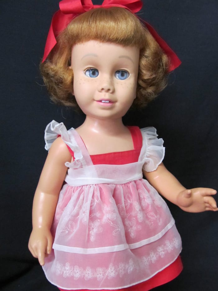 Doll & clothes are both very clean with no fading, rips, tears or damage, riveted snap closures on sun suit & pinafore are intact. Original red velvet Chatty shoes have some wear, the toe bows are a little faded.