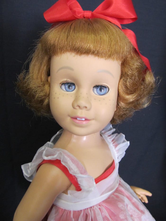 She is called a "prototype" as the first dolls were not marked on either the head or body. She is hard vinyl with a soft vinyl head and a fabric covered grill in the chest. Her neck turns and all joints work easily.