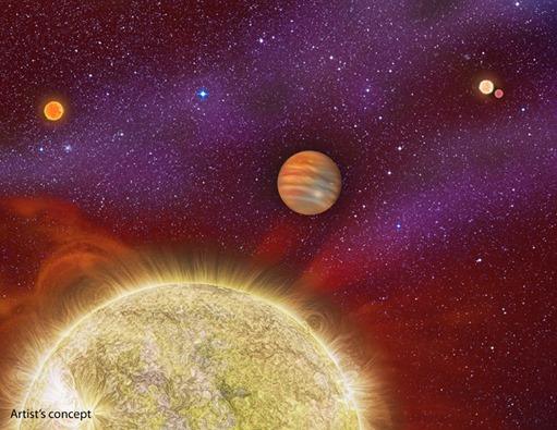 This artist's conception shows the 30 Ari system, which includes four stars and a planet. The planet, a gas giant, orbits its primary star (yellow) in about a year's time. The primary star, called 30 Ari B, has a companion -- the small "red dwarf" st