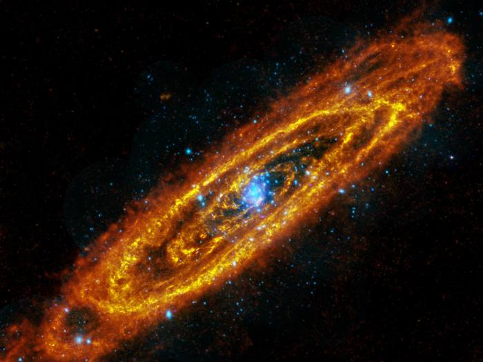 5. Andromeda Is So Hot And Cold: This mosaic of the Andromeda spiral galaxy highlights explosive stars in its interior, and cooler, dusty stars forming in its many rings. The image is a combination of observations from the Herschel Space Observatory