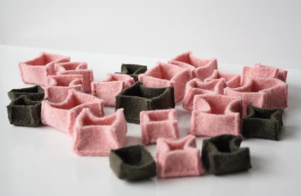 These tiny sweater boxes are for storing and partitioning a jewelry collection so that delicate earrings don't get scratched, and necklace chains don't get tangled - clever!