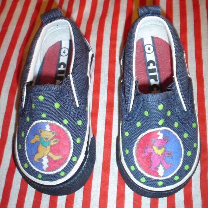 A pair of GD baby shoes made from recycled thrift store shoes, acrylic paint, and the method listed below.