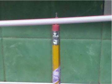 See how the pin goes through the straws and into the top of the eraser? You may need to slide the straws up and down on the pin a few times to widen the whole - so the arrow and tail can spin freely.