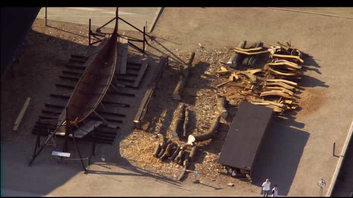 Aerial view looking down on the Viking shipyard, Roskilde Museum, Denmark with stored timbers and a ship awaiting completion on the stocks