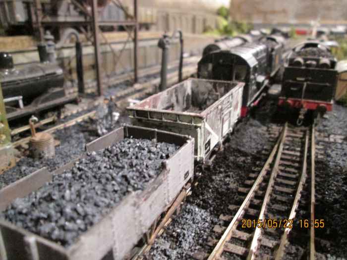 (Hornby) Dock Shunter with mineral wagons by the ash pit. The BR 16-tonner has one side door open for the man in the pit to get going, shovelling cooled ash and cinders. This was one of several drawbacks with steam operation - dirt, dust and grease