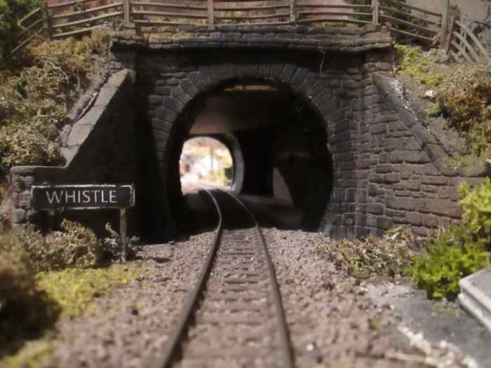 The tunnel from Thoraldby's side. No danger of being run over... Uh-oh, I dunno though. Something's rumbling under my feet. I've probably been looking the wrong way. 'Whistle' board has been moved forward - prototypically - since this view was taken