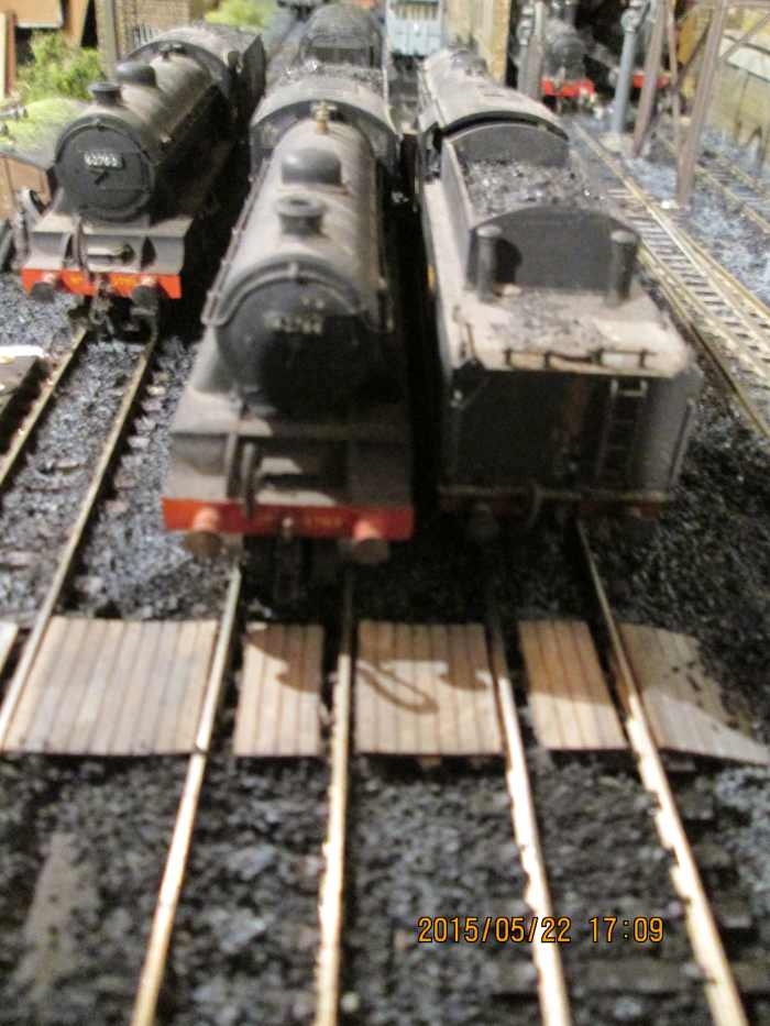 L-R, 1980's Hornby D49 62700 almost out of sight, Almost on the 'Poppy's timber barrow crossing are modified D49/2 62764 'The Garth' (from D49/1) and Bachmann WD 2-8-0 90446 (see below for contact link to Poppy's for a list of balsa model products)