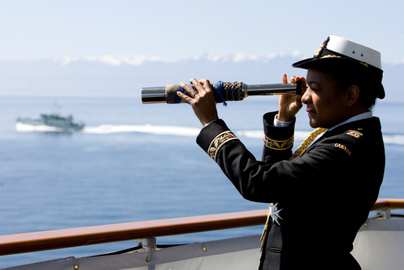 Governor General and Commander-in-Chief of the Canadian Forces Michalle Jean uses a spyglass on the HMCS Algonquin destroyer in Victoria, B.C. , June 2010