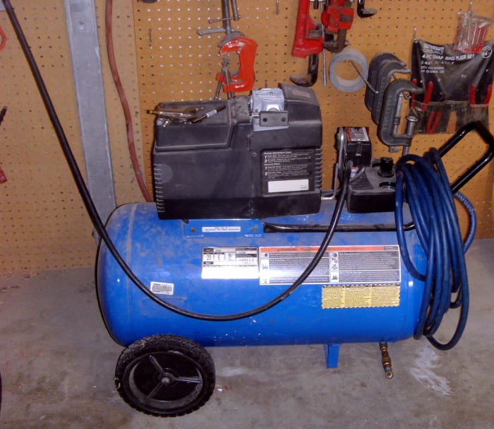 My own Devilbiss air compressor. Note the small tray on the upper left for accessories. This is a 5 HP, 20 gallon compressor producing 7 CFM at 90 PSI.