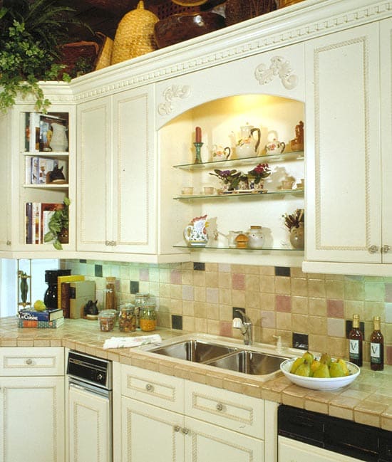 Alcove in the kitchen over the kitchen sink with glass shelves and decorative wood molding