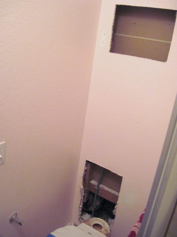 Two holes had to be cut into the wall before the leaking water pipe was found.