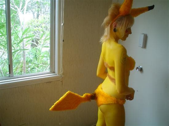 Pikachu Girl using a furry set with added tail and ears. She also painted her whole body yellow to look like pikachu.