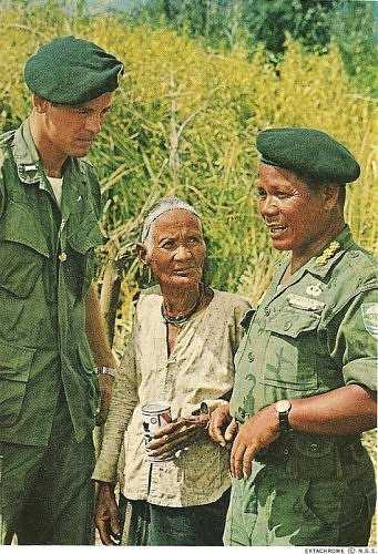 Capt. Do CAo Bo. Montagnard commander of An Lac confers with the camps XO, Lt. Carl Freeman III, and a village matriarch