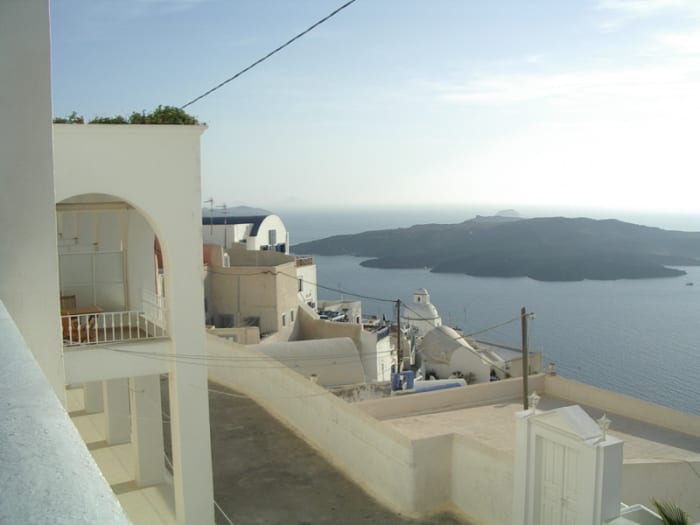 My photo from the cliff-tops of Thera, the largest island in Santorini's ring of islands which are all that's left of a larger island destroyed in 1600 BC. In the middle of the ring is Nea Kameni, the growing volcano that first appeared in 197 BC.