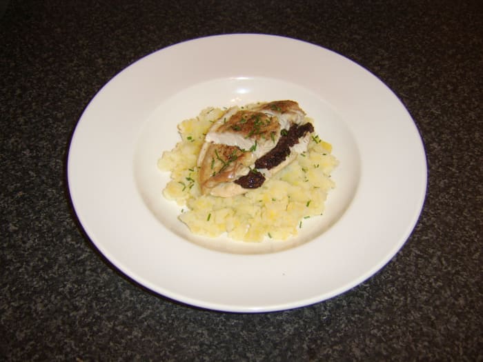 Chicken breast is stuffed with black pudding and baked in the oven, before being served on mashed potato and Swede turnip with chives