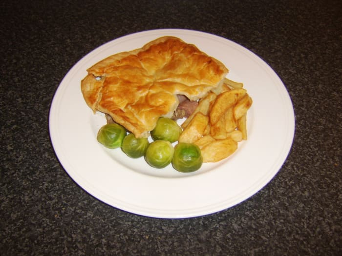 Diced beef and beef link sausages, topped with puff pastry, comprises a traditional Scottish steak pie