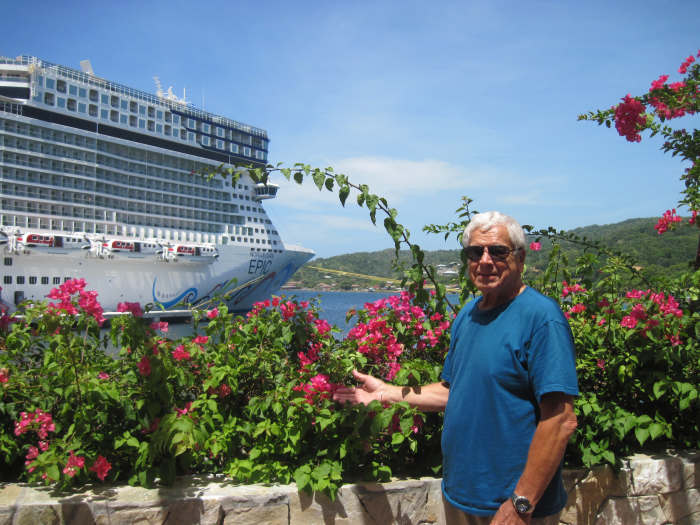 Chuck Hellier on the island of Roatan with the cruise ship Norwegian Epic in the background.