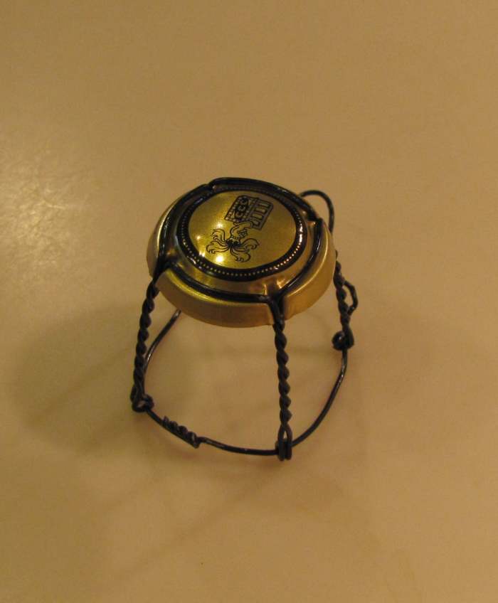 This is the wire frame from a champagne cork. With some rearranging, you can turn it into a tiny chair like one you see in an ice cream shop.
