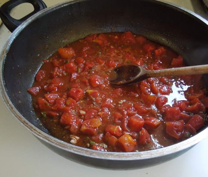 Cook and stir over medium high heat. Mixture should be boiling. As it cooks it will thicken and lose liquid.