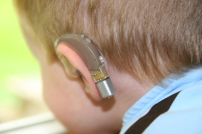 Personal FM receivers clip onto special boots that fit into the bottom of a hearing aid. The speaker's voice is transmitted directly to the hearing aids, reducing the problem of background noise.