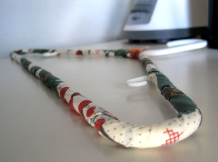 This is a plastic hanger, but you can see how easy it is to wrap a long strip of fabric around a hanger to decorate it and add some padding.