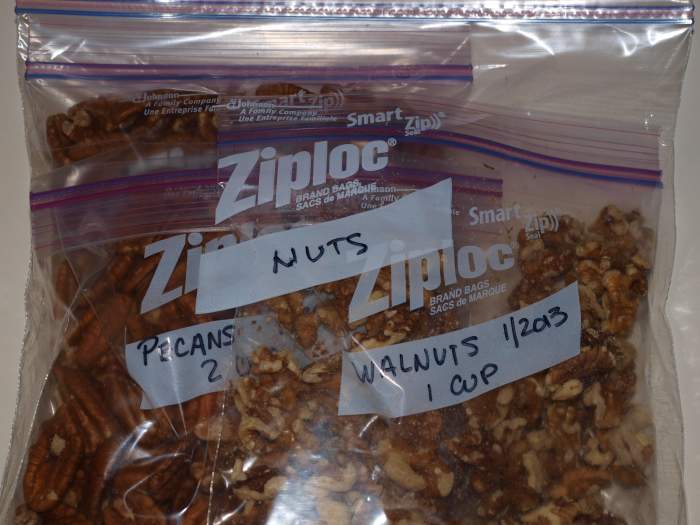 Small bags of nuts are placed inside a larger freezer bag for protection against food odors and dampness.