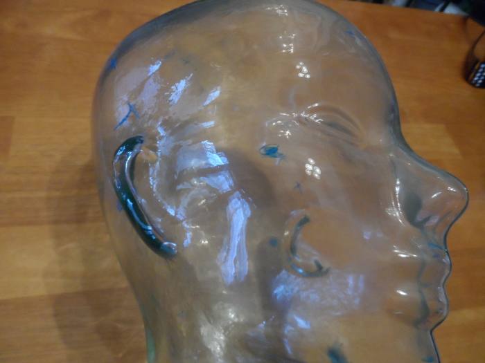 Glass face bust displaying areas wires are attached to a patient's head during a sleep study.