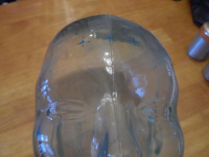 Glass face bust displaying areas wires are attached to a patient's head during a sleep study.