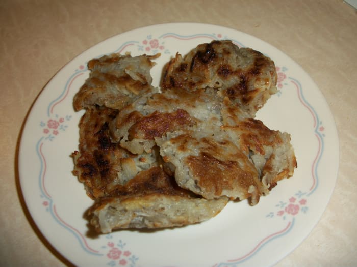 These hash browns really are brown! Take a 12-inch sauté pan and cover it with olive oil on medium high heat. Make sure the oil is hot before adding the shredded potatoes. The potatoes will form into a cake.
