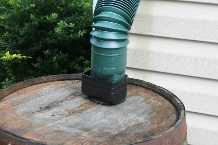 Funnel water from a downspout into a rain barrel.Attach a soaker hose to the barrel, and snake the hose through your flowerbed.