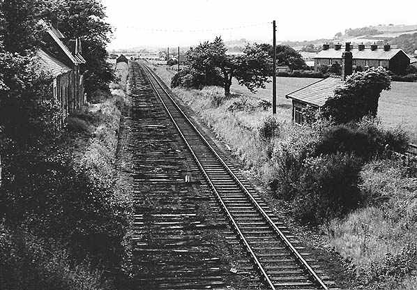 Pinchinthorpe Station in June, 1965, over a year after the closure to passengers, not long before rails are lifted. Trackbed is now a public footpath and station building is a private residence. There's a brick waiting shelter on the down platform