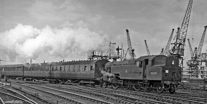 Darlington 4MT 2-6-4 Fairburn tank loco 42085 leaves Middlesbrough for Saltburn past Guisborough Junction with local stopping train. (Note dock cranes in background and steel-bodied twin-articulated coach set behind loco, Gresley teak set beyond).
