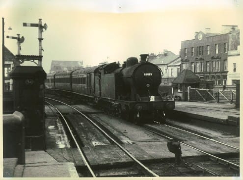 A8 4-6-2T with non-corridor stock enters Middlesbrough Station over Sussex Street level crossing from Thornaby (Darlington) direction with a train of mixed pre-1948 passenger stock. These locos were rebuilt in 1920s from Raven H1 4-4-4T