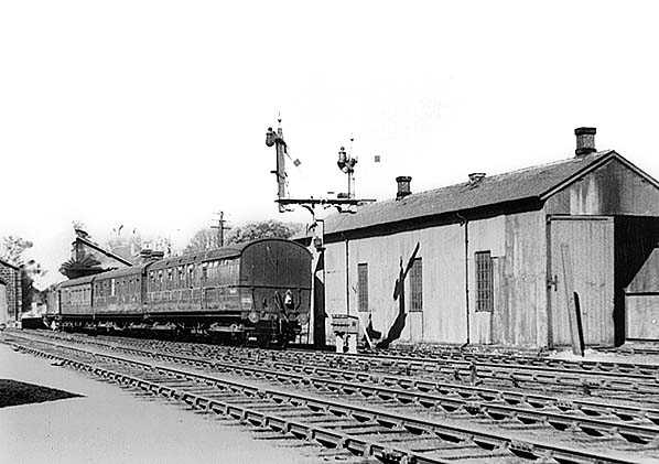 A train is pushed back out of Guisborough Station by an unidentified tank locomotive - heading east for Loftus - past Guisborough's small motive power depot, a sub-shed of Middlesbrough