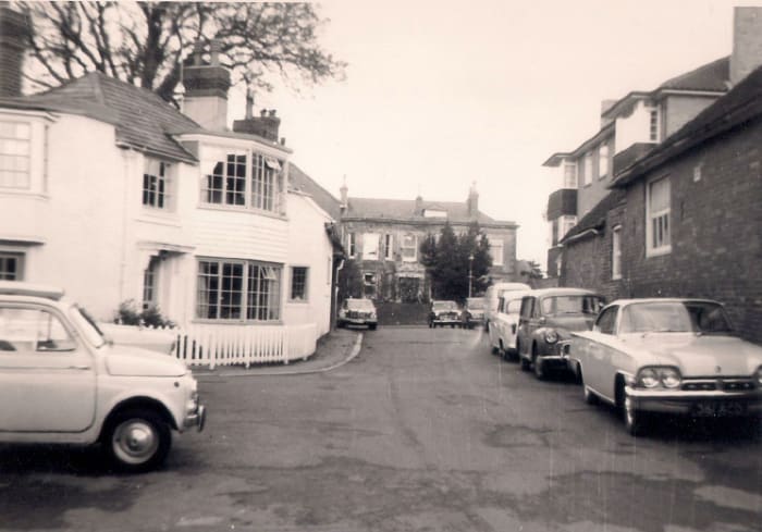 the High Street in the background, this lane housed the doctor's surgery and the village hall - Love the Cars!!