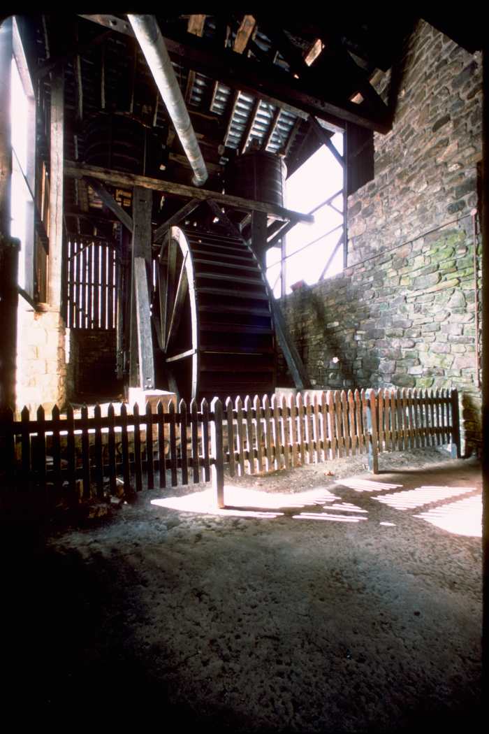 A huge water wheel supplied power to the industrial bellows blowing blasts into the furnace at Hopewell.