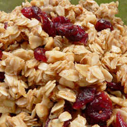 This delicious stovetop granola begins with toasting oats in olive oil and is sweetened with brown sugar, honey and dried cranberries.