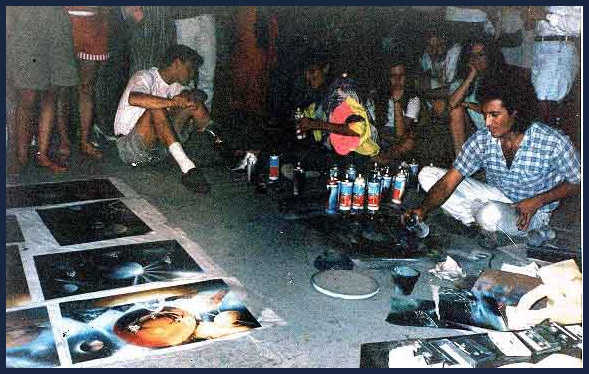 Gerardo Amor doing spray paint art on the Malecon of Puerto Vallarta, Ruben Melody is to his left