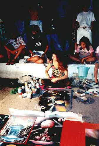 Alisa Amor painting on the Malecon of Puerto Vallarta, notice the student behind her taking careful note
